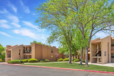 an apartment building with trees in front of it at Acacia Gardens, New Mexico, 87111